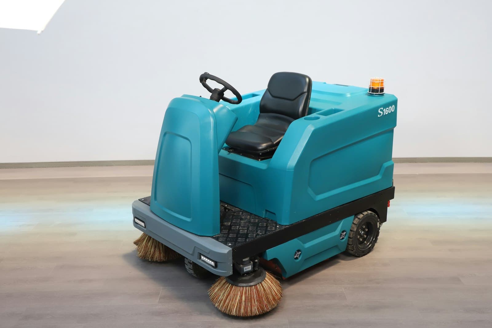 Ride-on floor sweeper with side brushes