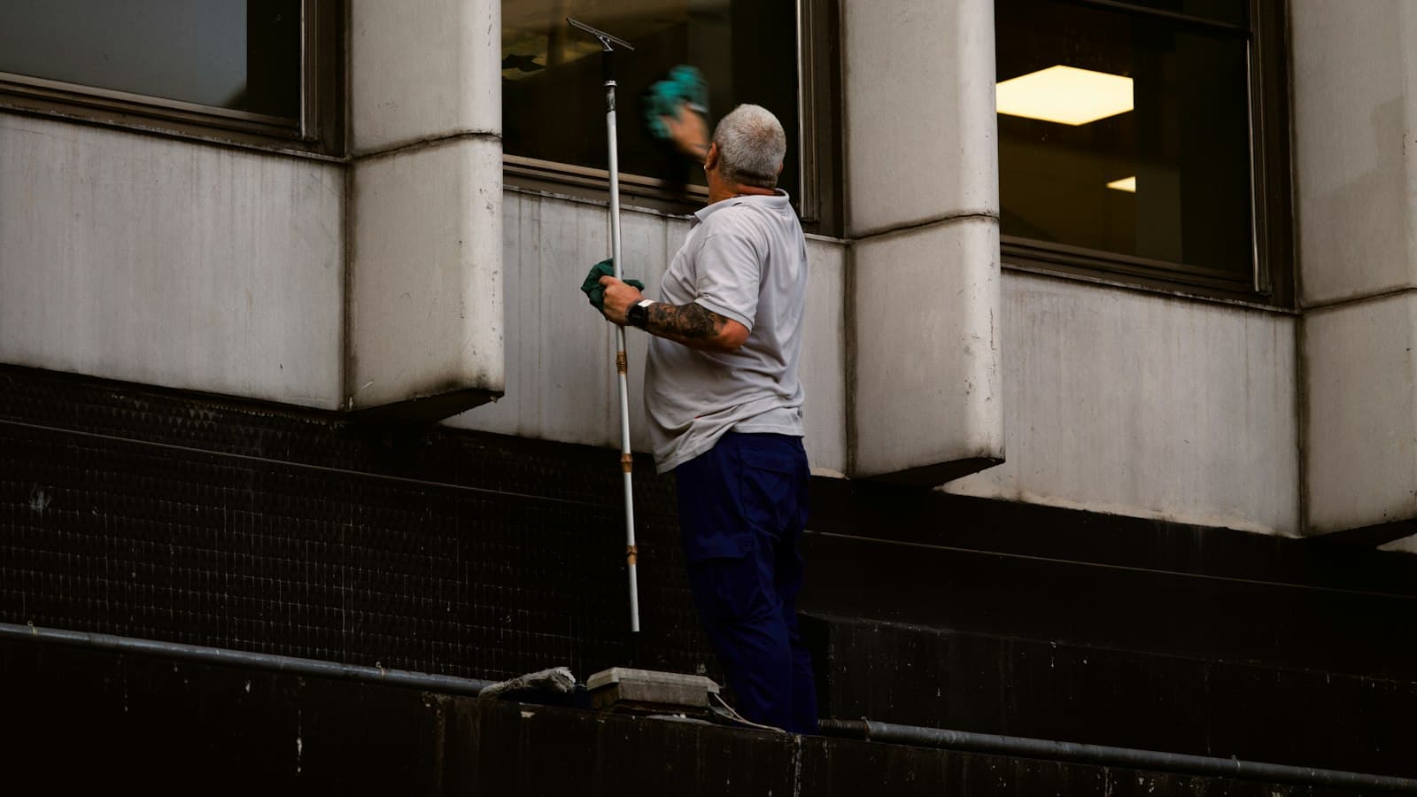 Window cleaner using a pole to clean exterior glass
